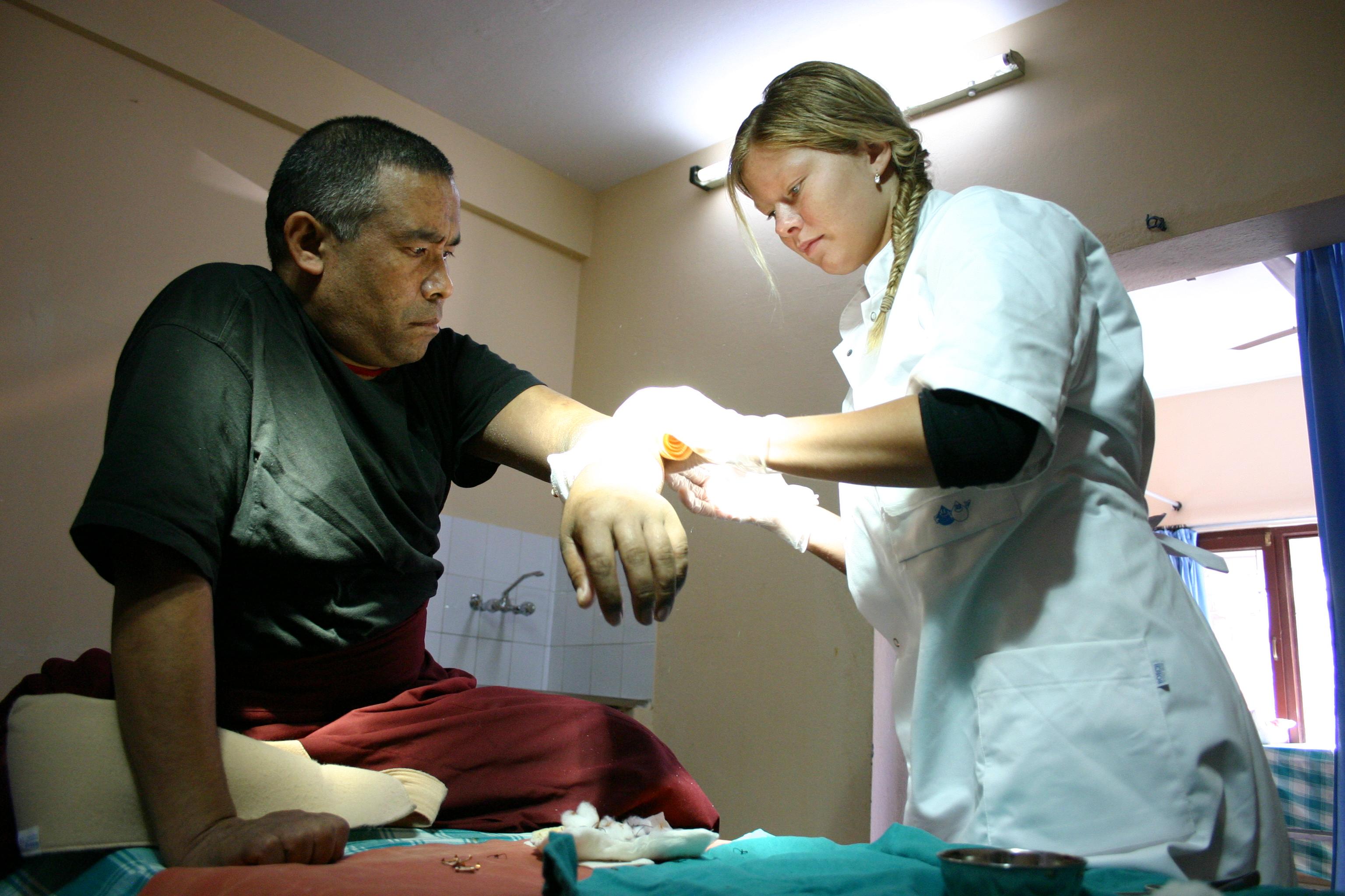 An intern from Projects Abroad cleaning a wound of a patient whilst on her nursing internship in Nepal. Projects Abroad intern pictured cleaning a patients wound as part of her nursing internship in Nepal.